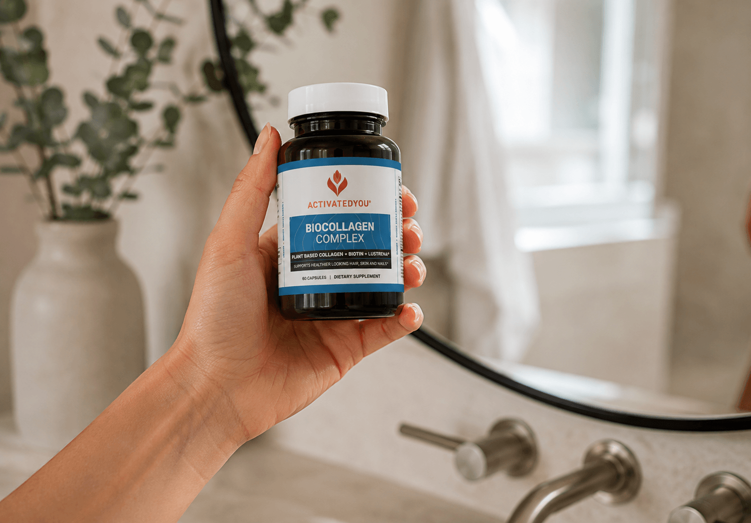 Hand holding BioCollagen Complex bottle by ActivatedYou in bathroom setting