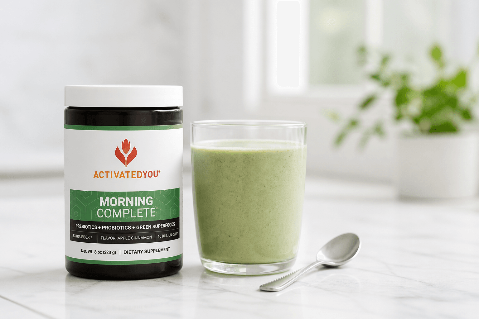 Jar of ActivatedYou Morning Complete with a mixed green smoothie drink and glass of water on a kitchen counter