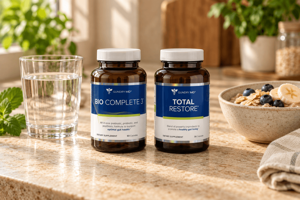 Bio Complete 3 and Total Restore bottles side by side on a stone countertop